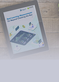 Cover image for the Brandon Hall Report titled 'Real Learning Measurement: Go Beyond Checking the Box,' featuring insights from Upside Learning. The report guides organizations on leveraging data from across the business to measure real results and become more predictive in learning measurement.