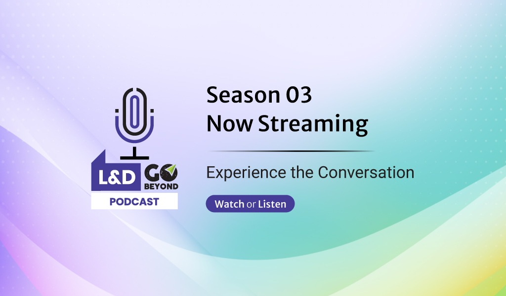 Man in glasses working on a laptop at a desk with documents and a plant, next to text promoting Upside Learning’s eBook “Beyond Training: An Actionable Guide to Learning That Delivers Measurable Business Impact,” with a Download Now button.